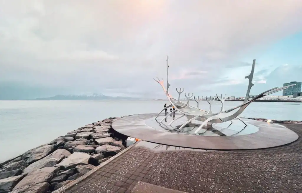 Sun Voyager sculpture on Reykjavik waterfront with pink and blue sky in the background.