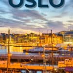 Oslo harbour at sunset with boats and illuminated buildings reflecting on the water.
