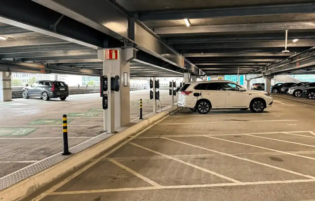 Underground car park with parked cars and marked parking spaces.
